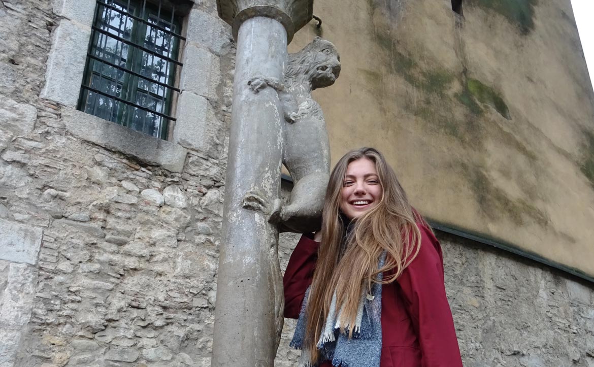 Polina Nenasheva a l'escultura de la lleona de Girona, durant una sortida amb el Voluntariat Lingüístic